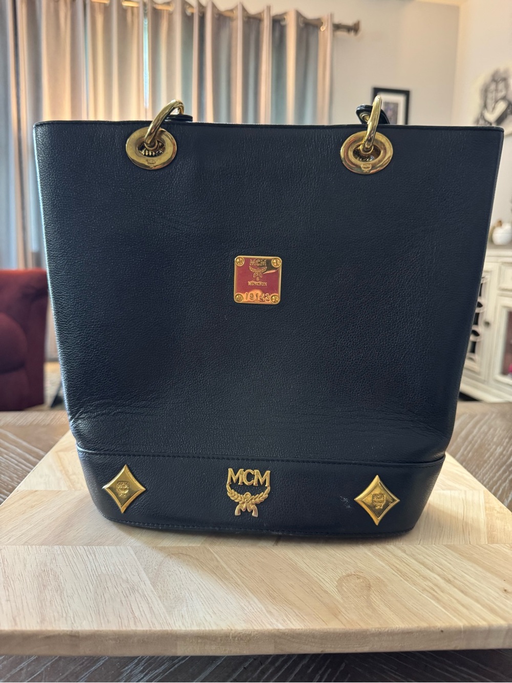 vintage black leather MCM bucket tote bag featuring gold-tone hardware!